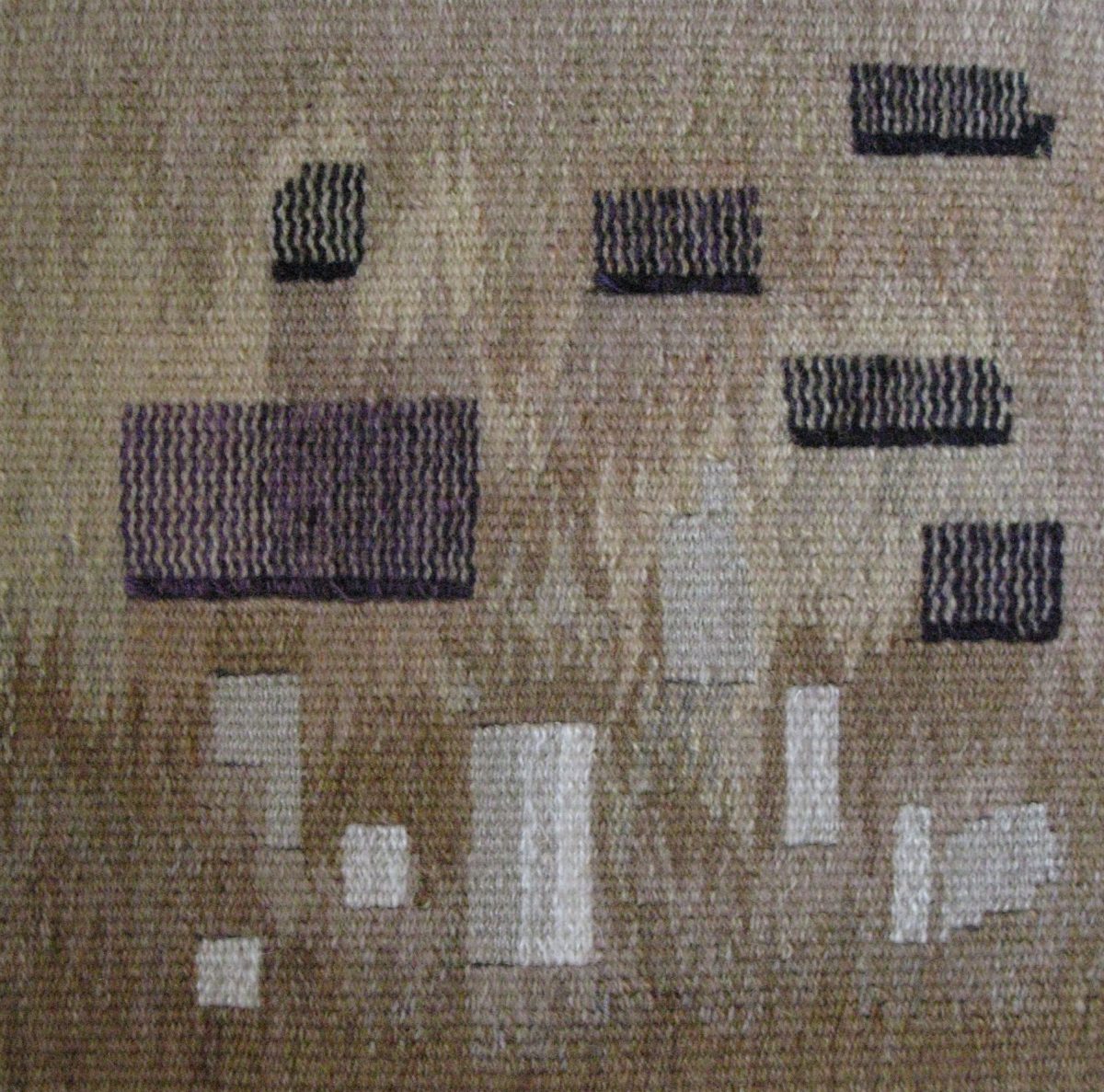 woven tapestry with varying sizes of blocks